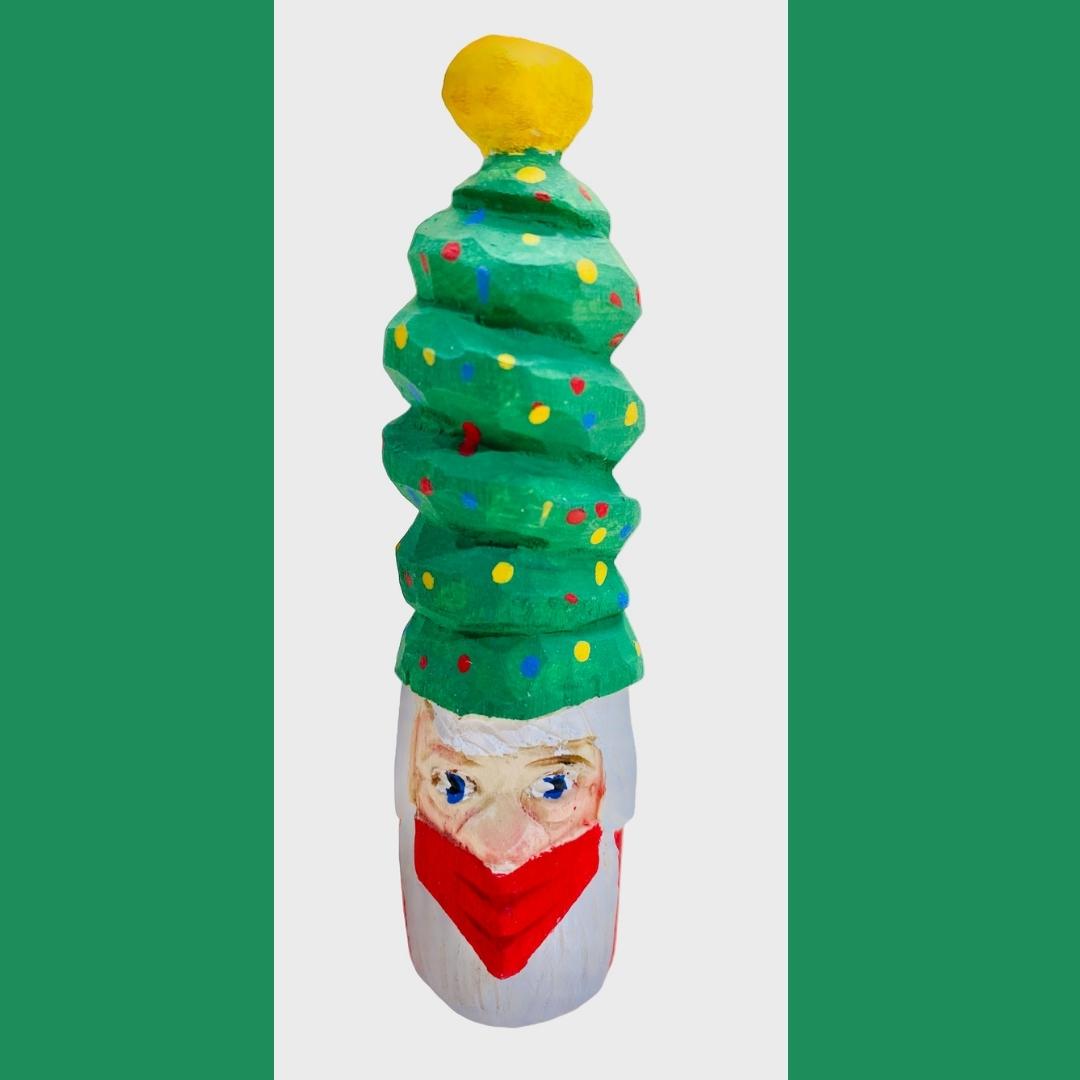 Hand Carved Santa Claus wearing a face mask and Christmas tree hat.  Christmas ornament 4"